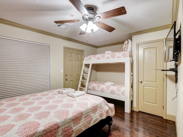 bedroom with ornamental molding, dark wood-style floors, ceiling fan, and visible vents