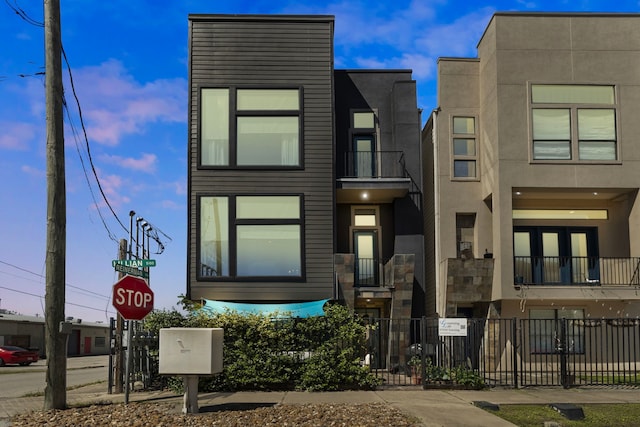 view of front facade featuring fence and stucco siding