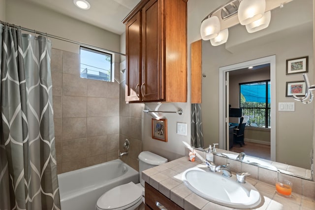 full bath with a healthy amount of sunlight, vanity, toilet, and shower / tub combo with curtain