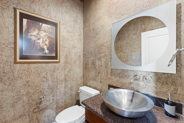 half bath featuring toilet and vanity