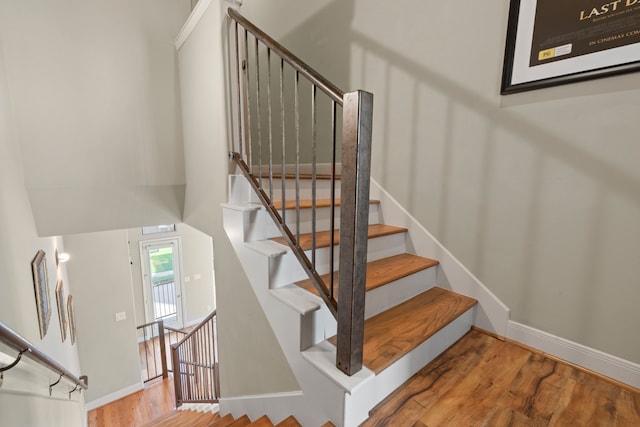 stairs with baseboards and wood finished floors