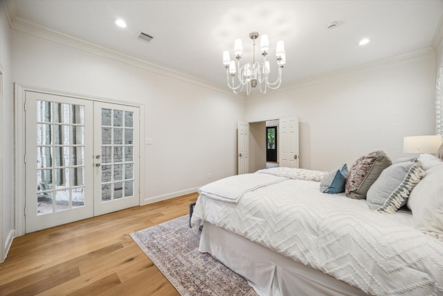 bedroom featuring french doors, ornamental molding, visible vents, light wood finished floors, and a notable chandelier