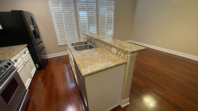 1718 Elgin St, Houston, TX 77004 - kitchen featuring a sink, range, dark wood-style floors, baseboards, and freestanding refrigerator