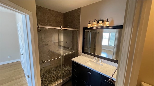 1718 Elgin St, Houston, TX 77004 - full bathroom with a shower stall, wood finished floors, vanity, and baseboards