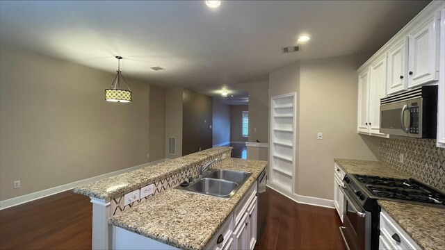 1718 Elgin St, Houston, TX 77004 - kitchen with appliances with stainless steel finishes, a sink, baseboards, dark wood-style flooring, and decorative backsplash