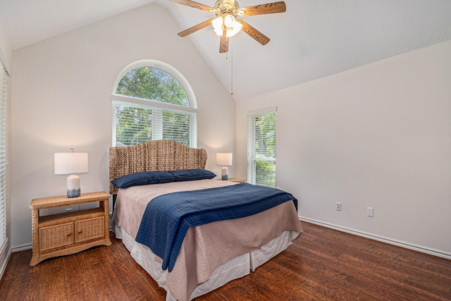 bedroom featuring baseboards, multiple windows, and hardwood / wood-style floors