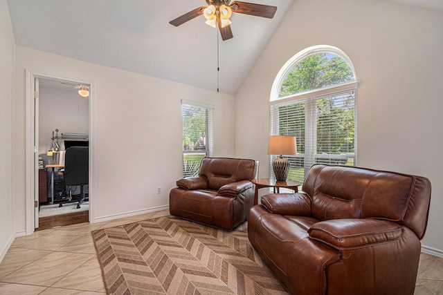 living room featuring light tile patterned floors, high vaulted ceiling, ceiling fan, and baseboards