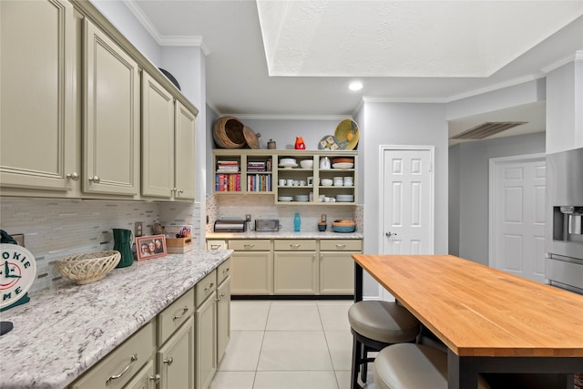20415 Aspenwilde Dr, Cypress, TX 77433 - kitchen with decorative backsplash, open shelves, ornamental molding, butcher block countertops, and light tile patterned floors