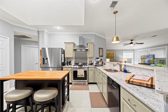 20415 Aspenwilde Dr, Cypress, TX 77433 - kitchen featuring wall chimney range hood, appliances with stainless steel finishes, a sink, butcher block countertops, and visible vents