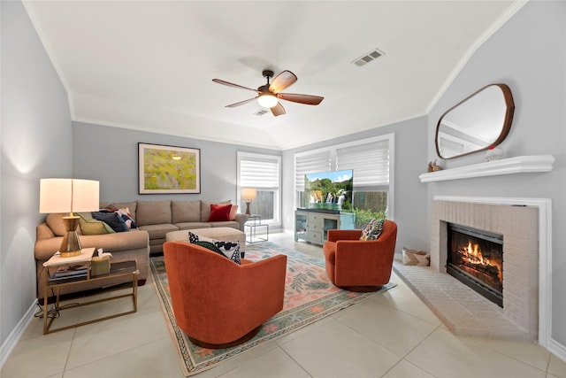 20415 Aspenwilde Dr, Cypress, TX 77433 - living area featuring a ceiling fan, visible vents, crown molding, a brick fireplace, and light tile patterned flooring
