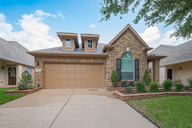 french country inspired facade with brick siding and driveway