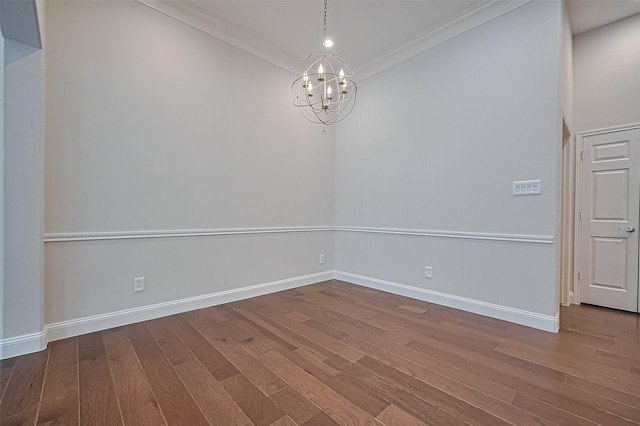 unfurnished dining area with baseboards, an inviting chandelier, ornamental molding, and wood finished floors