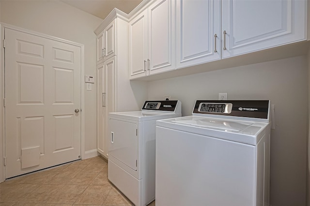 clothes washing area with cabinet space, separate washer and dryer, and light tile patterned flooring