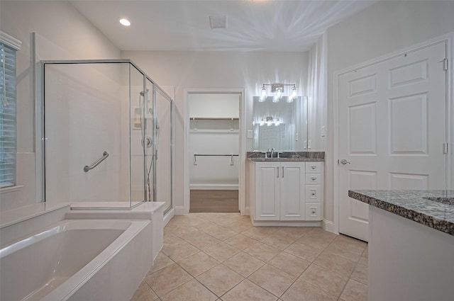 bathroom featuring a garden tub, tile patterned floors, a stall shower, and visible vents