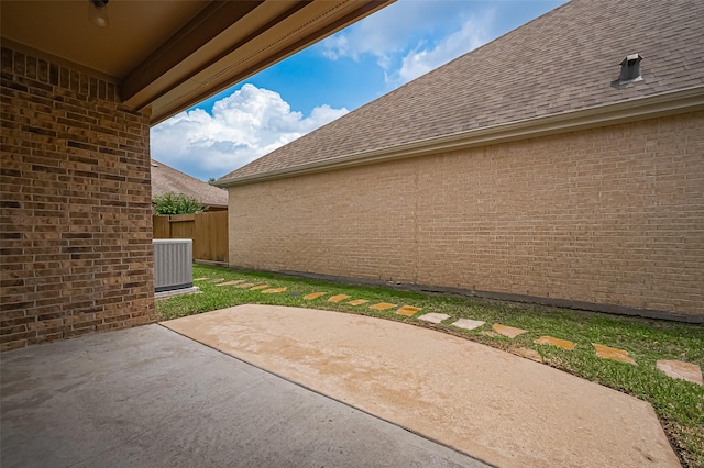 view of patio with fence and central AC unit