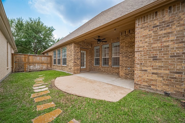 view of yard with fence, a ceiling fan, and a patio area