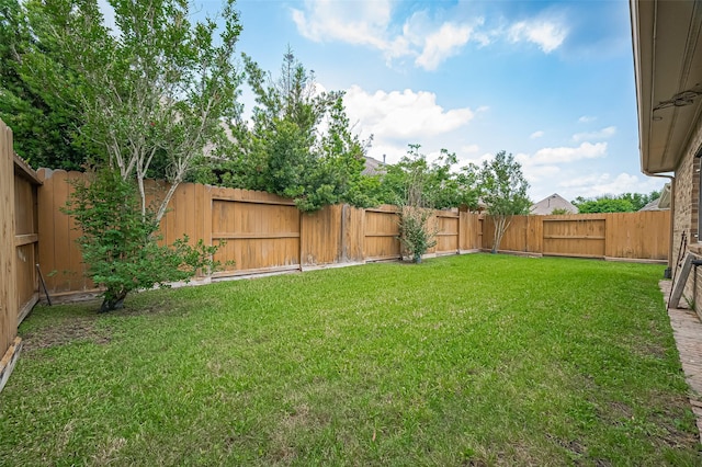 view of yard with a fenced backyard