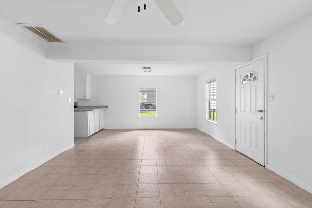 6090 Skylane Dr, Montgomery, TX 77316 - unfurnished living room with light tile patterned floors, baseboards, ceiling fan, and visible vents