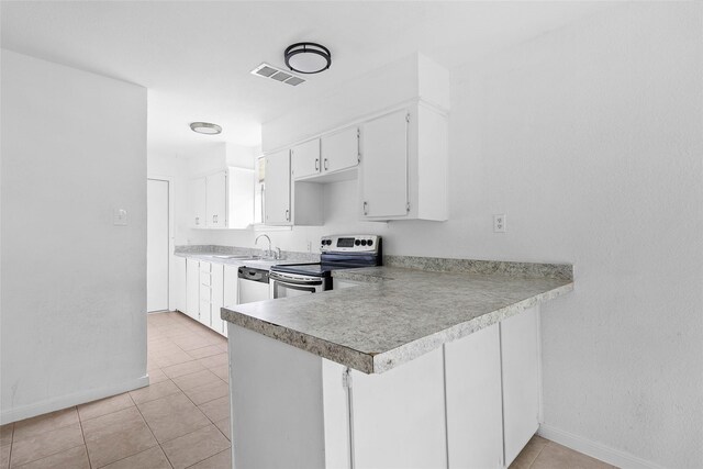 6090 Skylane Dr, Montgomery, TX 77316 - kitchen featuring baseboards, appliances with stainless steel finishes, light tile patterned floors, and visible vents