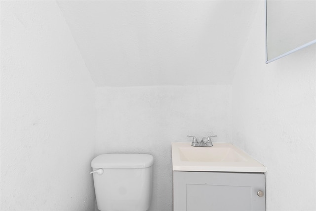6090 Skylane Dr, Montgomery, TX 77316 - half bathroom featuring toilet, lofted ceiling, and vanity
