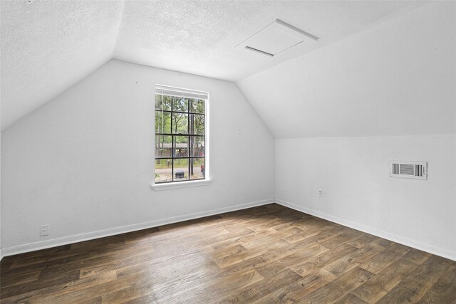 6090 Skylane Dr, Montgomery, TX 77316 - bonus room featuring visible vents, a textured ceiling, lofted ceiling, and wood finished floors
