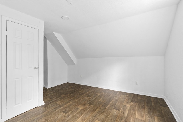 6090 Skylane Dr, Montgomery, TX 77316 - bonus room featuring baseboards, lofted ceiling, and dark wood-type flooring