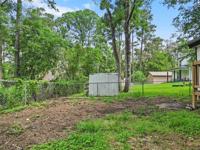 6090 Skylane Dr, Montgomery, TX 77316 - view of yard featuring a storage unit, an outdoor structure, and a fenced backyard