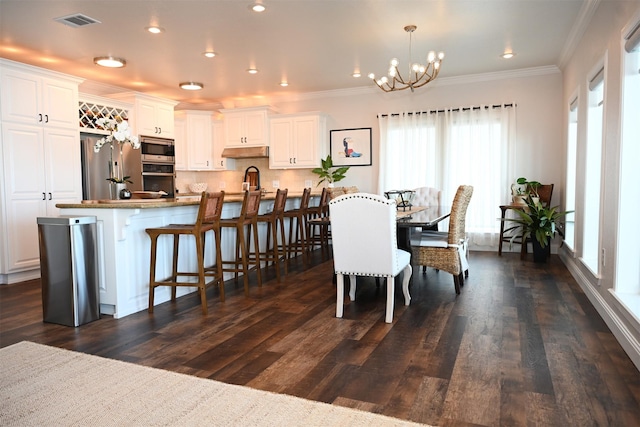 dining space featuring visible vents, ornamental molding, recessed lighting, a chandelier, and dark wood finished floors