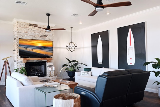 living area with visible vents, a fireplace, baseboards, a ceiling fan, and dark wood finished floors