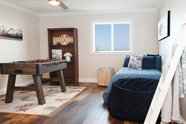 living area with baseboards, ornamental molding, dark wood finished floors, and ceiling fan
