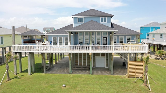 back of property featuring roof with shingles, a carport, and a wooden deck