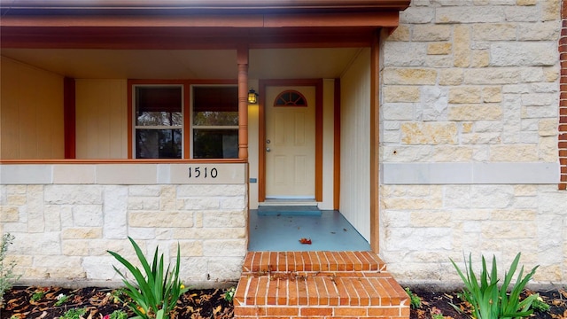 view of exterior entry featuring stone siding