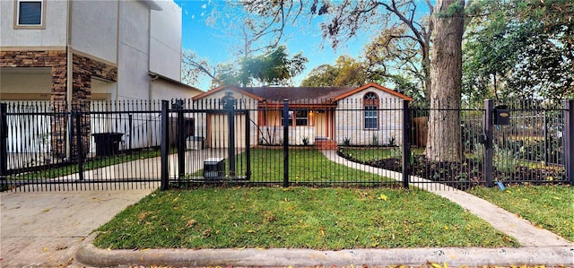 view of front facade with driveway, a fenced front yard, a gate, a front lawn, and stone siding
