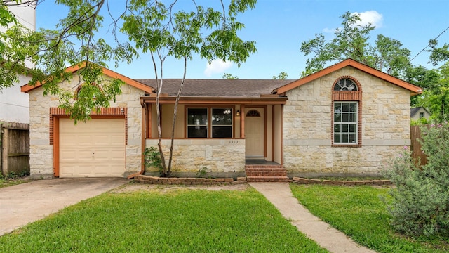 ranch-style home with a front yard, stone siding, a shingled roof, an attached garage, and driveway