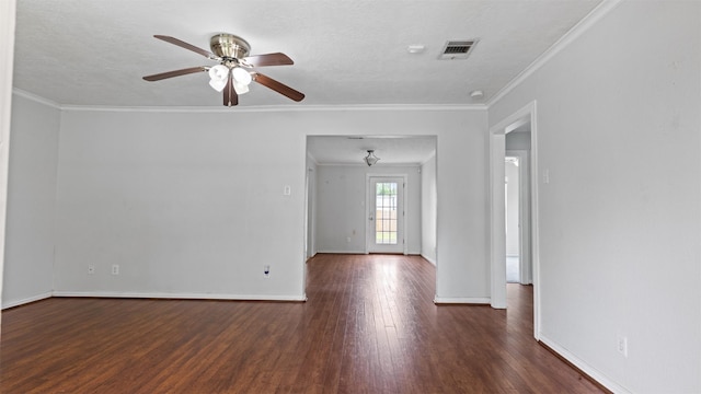 empty room with visible vents, a ceiling fan, baseboards, and wood finished floors