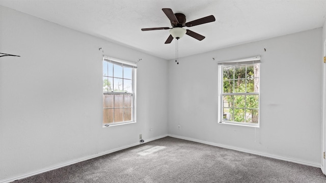 empty room with plenty of natural light, baseboards, carpet floors, and ceiling fan