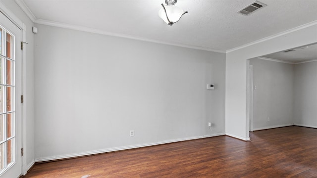 unfurnished room with crown molding, baseboards, wood finished floors, and visible vents