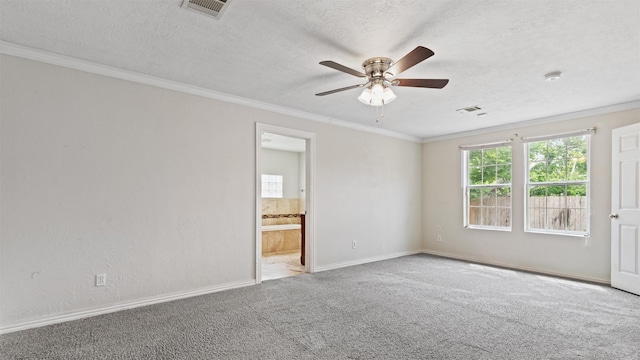 unfurnished room with ceiling fan, visible vents, crown molding, baseboards, and carpet flooring