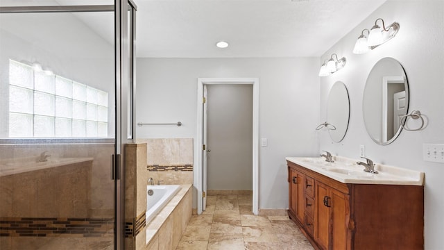 bathroom featuring a sink, double vanity, a stall shower, and a bath