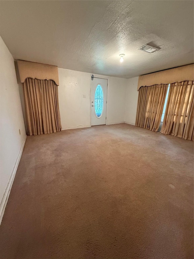 4300 Weaver Rd, Houston, TX 77016 - spare room with baseboards, a textured ceiling, and light colored carpet