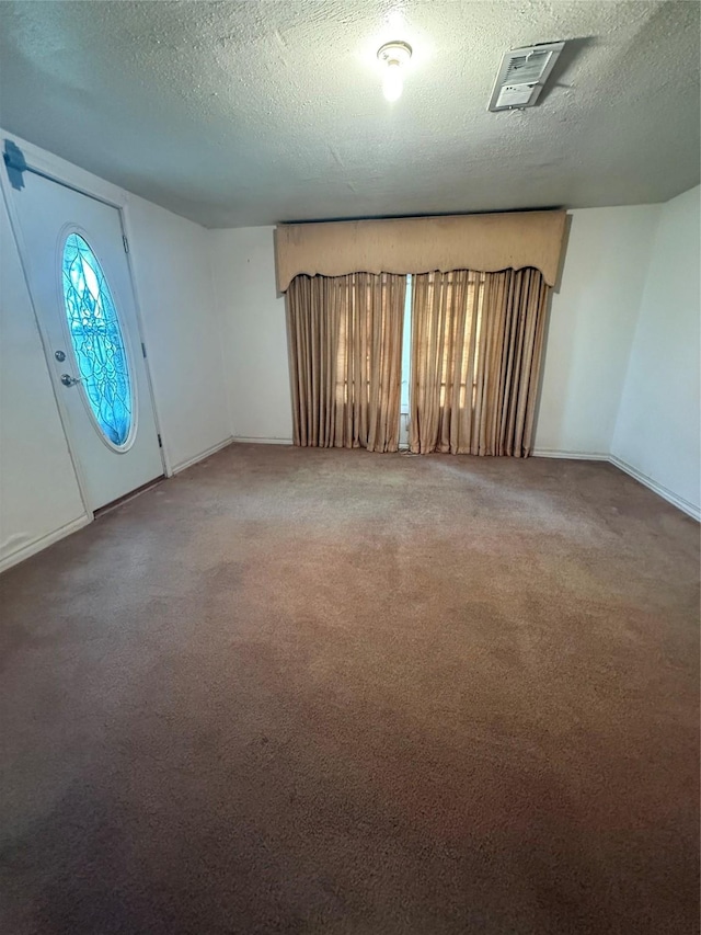 4300 Weaver Rd, Houston, TX 77016 - foyer featuring carpet floors, a textured ceiling, and visible vents