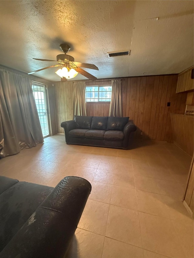 4300 Weaver Rd, Houston, TX 77016 - living area with wooden walls, a textured ceiling, and visible vents