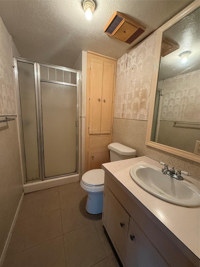 4300 Weaver Rd, Houston, TX 77016 - bathroom with vanity, toilet, a textured ceiling, tile patterned floors, and a stall shower