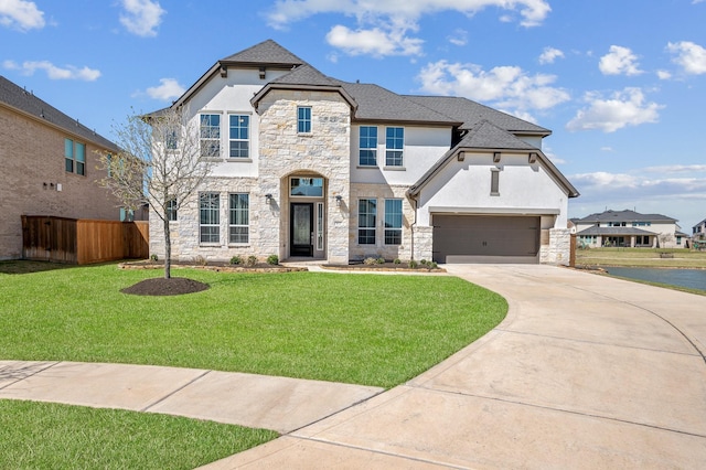453 Stratus View Ct, Katy, TX 77493 - french country inspired facade featuring fence, a front lawn, stone siding, stucco siding, and concrete driveway