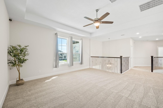 453 Stratus View Ct, Katy, TX 77493 - carpeted spare room featuring a ceiling fan, baseboards, visible vents, and a raised ceiling