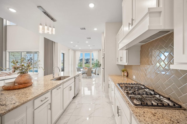 453 Stratus View Ct, Katy, TX 77493 - kitchen featuring appliances with stainless steel finishes, tasteful backsplash, a sink, light stone counters, and white cabinets