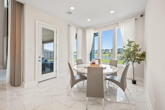 453 Stratus View Ct, Katy, TX 77493 - dining room featuring a water view, baseboards, marble finish floor, and visible vents