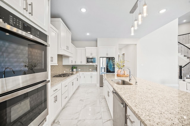 453 Stratus View Ct, Katy, TX 77493 - kitchen featuring a sink, light stone counters, marble finish floor, stainless steel appliances, and white cabinetry