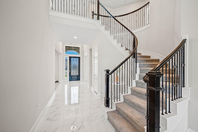 453 Stratus View Ct, Katy, TX 77493 - stairway with baseboards, marble finish floor, and a high ceiling