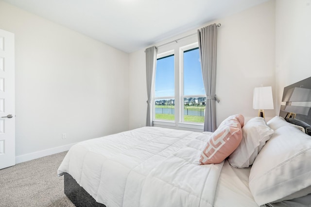 453 Stratus View Ct, Katy, TX 77493 - carpeted bedroom featuring baseboards and a water view